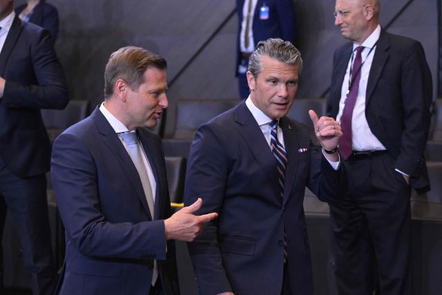 Estonia's Defence Minister Hanno Pevkur (L) and US Defense Secretary Pete Hegseth speak prior to a NATO Defence Ministers meeting at the NATO headquarters, in Brussels, on June 18, 2026. (Photo by JOHN THYS / AFP)