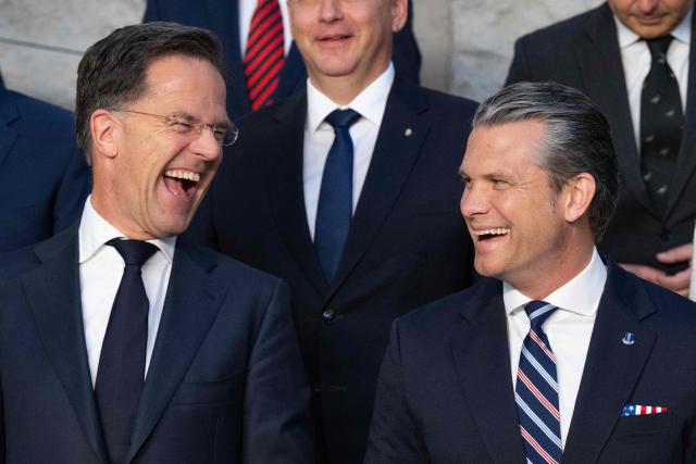 NATO Secretary General Mark Rutte (L) and US Defense Secretary Pete Hegseth react as they pose with Defence Ministers during a family photgraph on the sidelines of a NATO Defence Ministers meeting at the NATO headquarters, in Brussels, on June 18, 2026. (Photo by JOHN THYS / AFP)