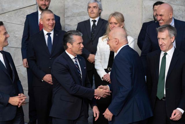 US Defense Secretary Pete Hegseth (center L) and Greece's Defence Minister Nikolaos Dendias shakes before a family photograph on the sidelines of a NATO Defence Ministers meeting at the NATO headquarters, in Brussels, on June 18, 2026. (Photo by JOHN THYS / AFP)