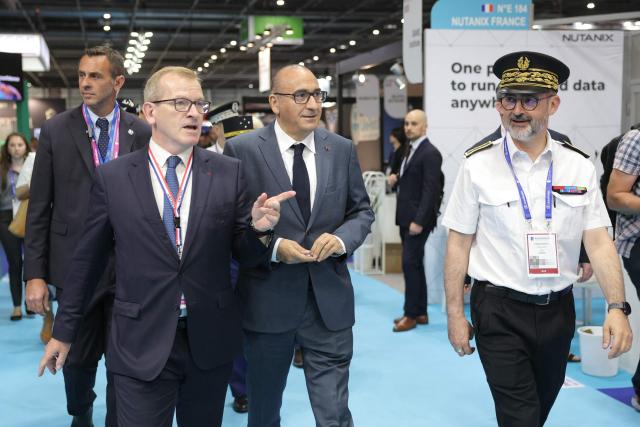 France's Interior Minister Laurent Nunez (C) visits Eurosatory, a land and airland defence and security trade fair, with President of the GICAT (Group of French Land and Air-Land Defense and Security Industries) Emmanuel Levacher (L) and Seine-Saint-Denis prefect Julien Charles (R) in Villepinte on the outskirts of Paris, on June 18, 2026. (Photo by Thomas SAMSON / AFP)
