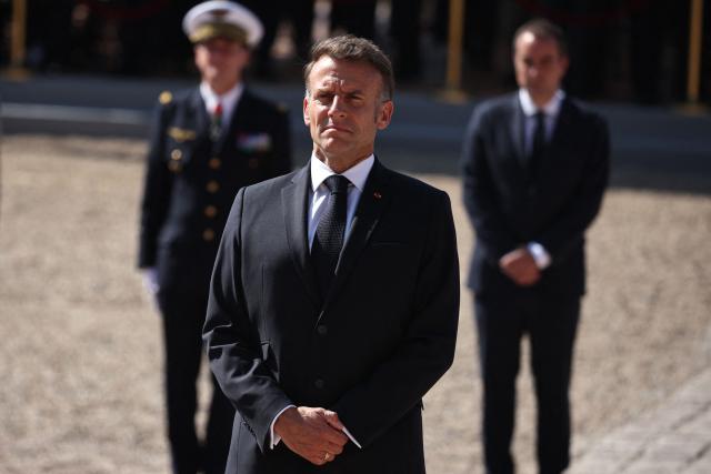France's President Emmanuel Macron (C) and France's Prime Minister Sebastien Lecornu (R) attend commemorative ceremony for the 86th anniversary of the Appeal of 18 June, in Mont Valerien, near Paris, on June 18, 2026. (Photo by SIMON WOHLFAHRT / POOL / AFP)