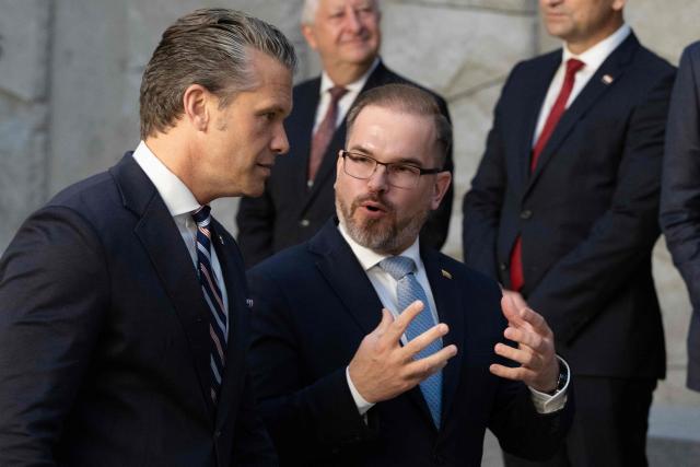 US Defense Secretary Pete Hegseth speaks with Lithuania's Defence Minister Robertas Kaunas before a family photograph on the sidelines of a NATO Defence Ministers meeting at the NATO headquarters, in Brussels, on June 18, 2026. (Photo by JOHN THYS / AFP)