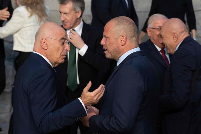 Greece's Defence Minister Nikolaos Dendias speaks with Belgium's Defence Minister Theo Francken before a family photograph on the sidelines of a NATO Defence Ministers meeting at the NATO headquarters, in Brussels, on June 18, 2026. (Photo by JOHN THYS / AFP)