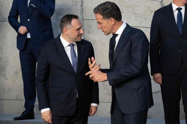 NATO Secretary General Mark Rutte speaks with Albania's Defence Minister Ermal Nufi (L) before a family photograph on the sidelines of a NATO Defence Ministers meeting at the NATO headquarters, in Brussels, on June 18, 2026. (Photo by JOHN THYS / AFP)
