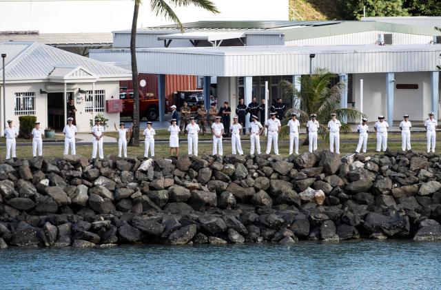 Naval officers stand guard along the shore as part of welcome ceremony for the French Overseas Patrol Vessel Jean Tranape navigating off the coast of Noumea in the French overseas collectivity of New Caledonia, on June 18, 2026. The Patrol Vessel Jean Tranape has joined the armed forces in New Caledonia at its new home port in Noumea. (Photo by Delphine MAYEUR / AFP)