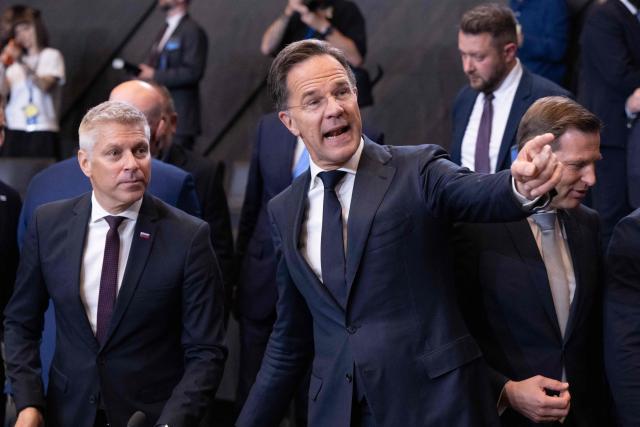 NATO Secretary General Mark Rutte gestures next to Slovenia's Defence Minister Valentin Hajdinjak (L) before a NATO Defence Ministers meeting at the NATO headquarters, in Brussels, on June 18, 2026. (Photo by JOHN THYS / AFP)