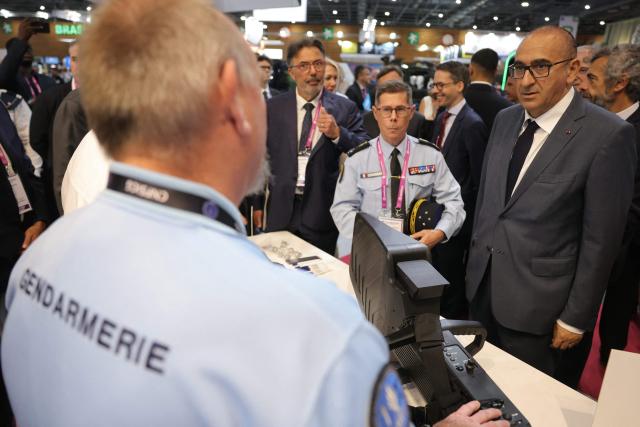 France's Interior Minister Laurent Nunez (R) reacts as he is presented a Sniper DP anti-drone jammer at the Interior Ministry's stand of Eurosatory, a land and airland defence and security trade fair in Villepinte on the outskirts of Paris, on June 18, 2026. (Photo by Thomas SAMSON / AFP)