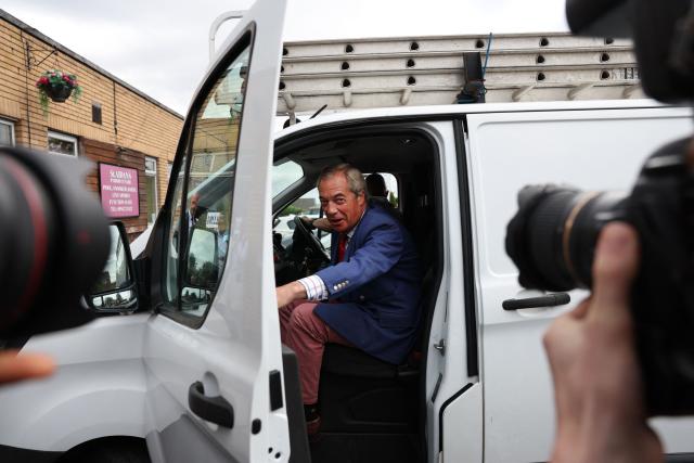 Reform UK Leader Nigel Farage exits the white van of Reform UK's candidate Rob Kenyon, as they arrive at a polling station for Kenyon to cast his vote in the the Makerfield by-election, in Winstanley, part of the Makerfield parliamentary constituency, in north-west England on June 18, 2026. Britain holds a unique vote on June 18 that could trigger the endgame for Labour leader Keir Starmer's beleaguered premiership, or win him a reprieve. (Photo by Darren Staples / AFP)