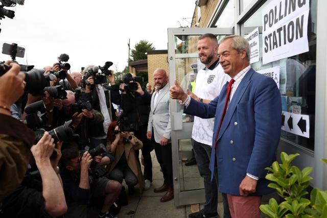 Reform UK's candidate Rob Kenyon and Reform UK Leader Nigel Farage poses for a photo as Kenyon arrives to cast his vote in the the Makerfield by-election, at a polling station in Winstanley, part of the Makerfield parliamentary constituency, in north-west England on June 18, 2026. Britain holds a unique vote on June 18 that could trigger the endgame for Labour leader Keir Starmer's beleaguered premiership, or win him a reprieve. (Photo by Darren Staples / AFP)
