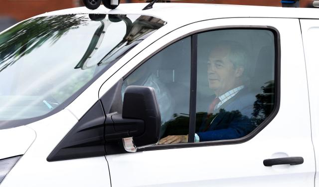 Reform UK Leader Nigel Farage sits in the passenger seat of the white van of Reform UK's candidate Rob Kenyon, as they arrive at a polling station for Kenyon to cast his voting in the the Makerfield by-election, in Winstanley, part of the Makerfield parliamentary constituency, in north-west England on June 18, 2026. Britain holds a unique vote on June 18 that could trigger the endgame for Labour leader Keir Starmer's beleaguered premiership, or win him a reprieve. (Photo by Darren Staples / AFP)