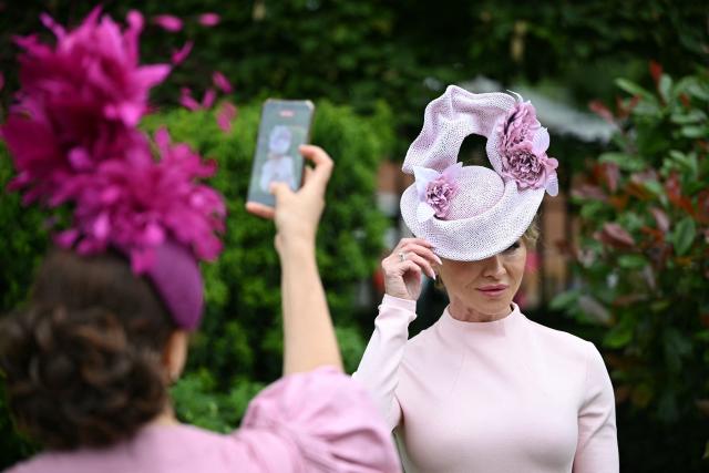 Racegoers pose for a photo as they arrive on the third day of the Royal Ascot horse racing meeting in Ascot, west of London, on June 18, 2026. (Photo by JUSTIN TALLIS / AFP)