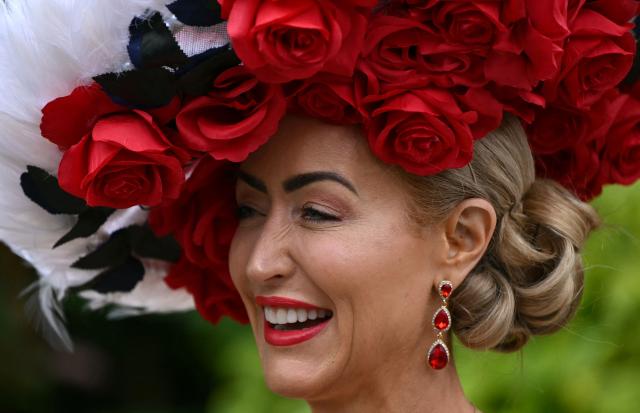 Racegoers pose for a photo as they arrive on the third day of the Royal Ascot horse racing meeting in Ascot, west of London, on June 18, 2026. (Photo by JUSTIN TALLIS / AFP)