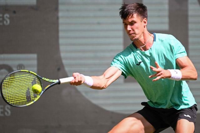 Hungary's Fabian Marozsan returns the ball to US' Taylor Fritz during their men's singles round of 16 tennis match of the Halle Open ATP tennis tournament in Halle, western Germany, on June 18, 2026. (Photo by CARMEN JASPERSEN / AFP)