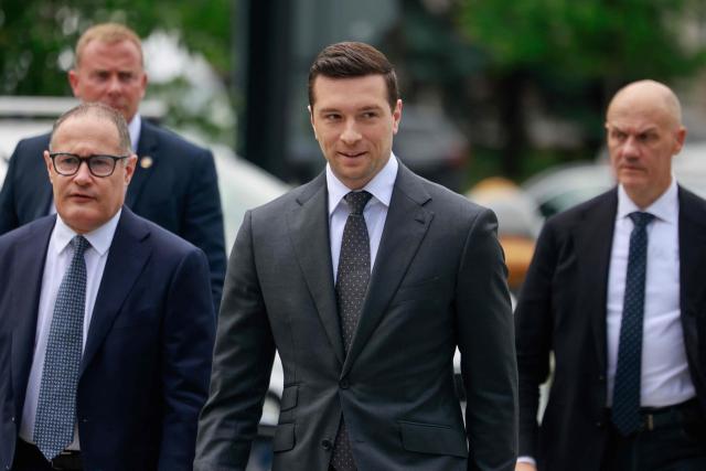 French far-right Rassemblement National (RN) party's President, member of the European Parliament and president of the Patriots for Europe (PfE) group Jordan Bardella (C), arrives for a wreath laying ceremony at the Monument to the Ghetto Heroes in Warsaw, Poland on June 18, 2026. Jordan Bardella is in Warsaw to meet with leaders of Polands far right, marking the latest stop on his overseas tour aimed at strengthening his European alliances just a few months before the French presidential election. (Photo by Wojtek RADWANSKI / AFP)