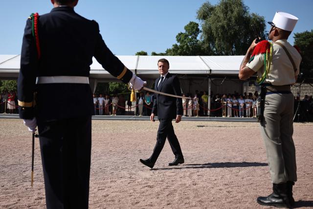 France's President Emmanuel Macron (C) attends the commemorative ceremony for the 86th anniversary of the Appeal of 18 June, in Mont Valerien, near Paris, on June 18, 2026. (Photo by SIMON WOHLFAHRT / POOL / AFP)