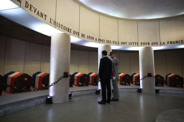 France's President Emmanuel Macron (L) and former General Chief of Staff of the French armed Forces Thierry Burkhard visit the memorial crypt during the commemorative ceremony for the 86th anniversary of the Appeal of 18 June, in Mont Valerien on June 18, 2026. (Photo by SIMON WOHLFAHRT / POOL / AFP)