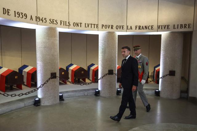France's President Emmanuel Macron (L) and former General Chief of Staff of the French armed Forces Thierry Burkhard visit the memorial crypt during the commemorative ceremony for the 86th anniversary of the Appeal of 18 June, in Mont Valerien on June 18, 2026. (Photo by SIMON WOHLFAHRT / POOL / AFP)