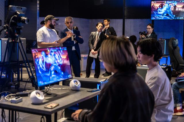 London's Mayor Sadiq Khan (C) visits the Red Bull Gaming Sphere Tokyo in the city's Nakano district on June 18, 2026. (Photo by Philip FONG / AFP)