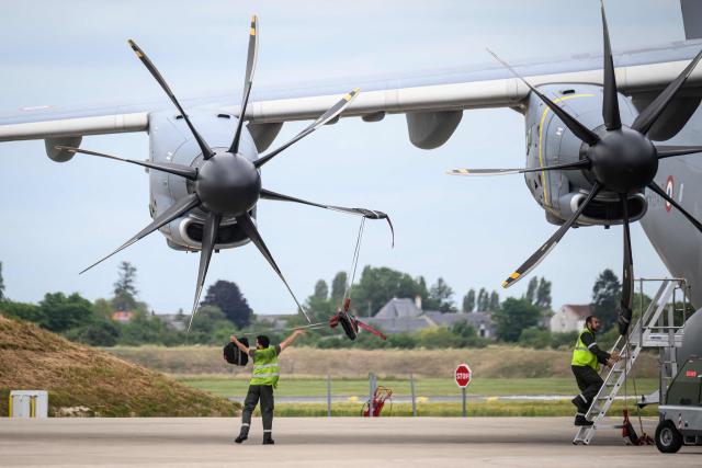A French airforce soldier ballasts the propellers of an Airbus military A400M Atlas plane after a joint military drill flight between French army and German army, at the 123 airforce Orleans-Bricy base in Bricy center France, on June 11, 2026.  (Photo by Loic VENANCE / AFP)
