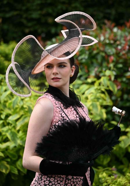 Racegoers pose for a photo as they arrive on the third day of the Royal Ascot horse racing meeting in Ascot, west of London, on June 18, 2026. (Photo by JUSTIN TALLIS / AFP)