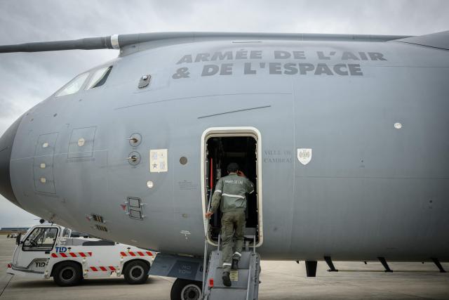 French airforce soldiers enter an Airbus military A400M Atlas planes during a joint military drill between French army and German army, at the 123 airforce Orleans-Bricy base in Bricy center France, on June 11, 2026.  (Photo by Loic VENANCE / AFP)