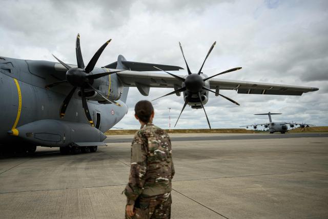 French airforce soldiers checks an Airbus military A400M Atlas plane after a joint military drill flight between French army and German army, at the 123 airforce Orleans-Bricy base in Bricy center France, on June 11, 2026.  (Photo by Loic VENANCE / AFP)
