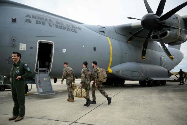 French airforce soldiers enter an Airbus military A400M Atlas planes during a joint military drill between French army and German army, at the 123 airforce Orleans-Bricy base in Bricy center France, on June 11, 2026.  (Photo by Loic VENANCE / AFP)
