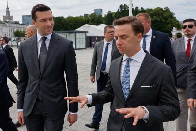 French far-right Rassemblement National (RN) party's President, member of the European Parliament and president of the Patriots for Europe (PfE) group Jordan Bardella (L) speaks with Poland's ultranationalist Confederation party (Konfederacja) president and Deputy Marshal of the Sejm of the Republic of Poland Krzysztof Bosak  (R) after a ceremony at the tomb of the Unknown Soldier at the Marshal Jozef Pilsudski Square in Warsaw, Poland on June 18, 2026. Jordan Bardella is in Warsaw to meet with leaders of Polands far right, marking the latest stop on his overseas tour aimed at strengthening his European alliances just a few months before the French presidential election. (Photo by Wojtek RADWANSKI / AFP)