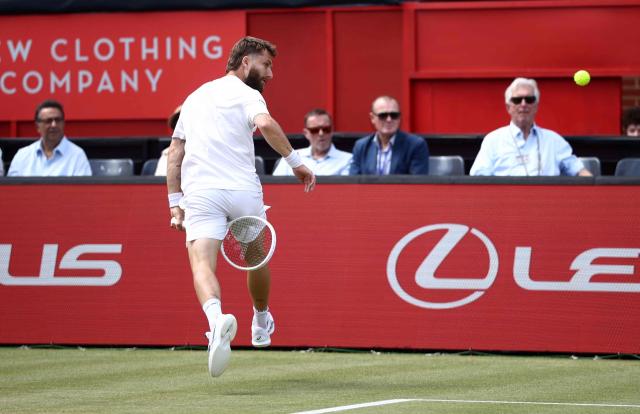 France's Corentin Moutet watches the ball after playing a shot between his legs to return against Spain's Alejandro Davidovich Fokina during their men's singles round of 16 tennis match on day three of the ATP HSBC Championships at Queen's Club in west London on June 18, 2026. (Photo by Henry NICHOLLS / AFP)