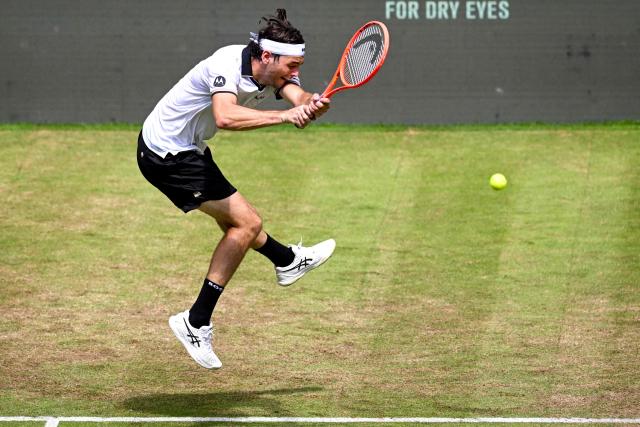 US' Taylor Fritz returns the ball to Hungary's Fabian Marozsan during their men's singles round of 16 tennis match of the Halle Open ATP tennis tournament in Halle, western Germany, on June 18, 2026. (Photo by CARMEN JASPERSEN / AFP)