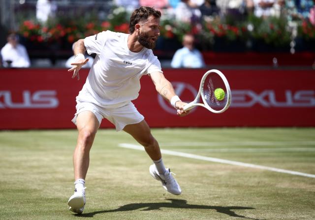 France's Corentin Moutet returns against Spain's Alejandro Davidovich Fokina during their men's singles round of 16 tennis match on day three of the ATP HSBC Championships at Queen's Club in west London on June 18, 2026. (Photo by Henry NICHOLLS / AFP)