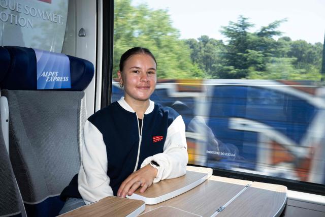 French short track speed skater Aurelie Leveque poses for a picture on a train bound for Briançon on June 18, 2026, ahead of a ceremony to unveil the emblems for the French Alps 2030 Winter Olympic Games. (Photo by Miguel MEDINA / AFP)