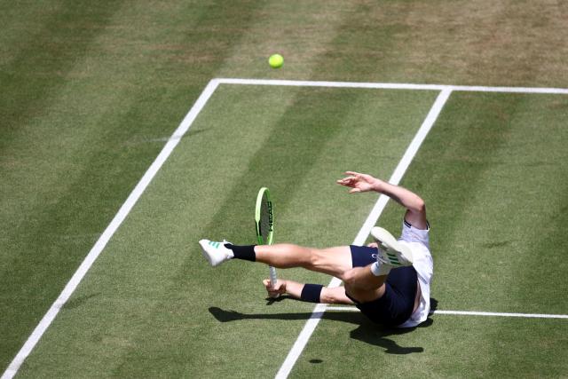 Spain's Alejandro Davidovich Fokina dives to play a return against France's Corentin Moutet during their men's singles round of 16 tennis match on day three of the ATP HSBC Championships at Queen's Club in west London on June 18, 2026. (Photo by Henry Nicholls / AFP)
