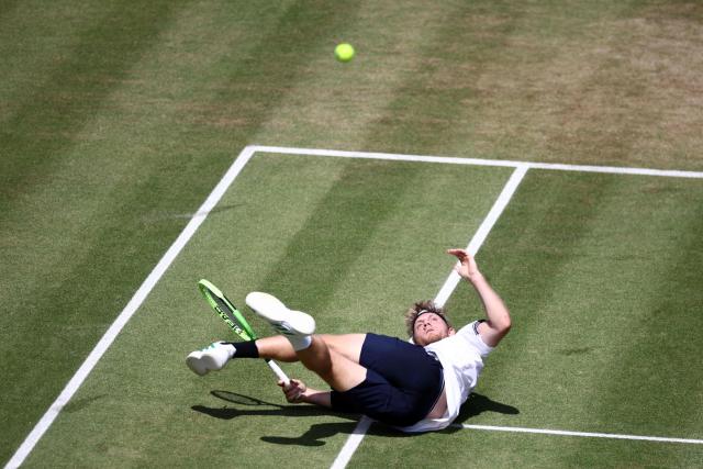 Spain's Alejandro Davidovich Fokina watches the ball as after diving to play a return against France's Corentin Moutet during their men's singles round of 16 tennis match on day three of the ATP HSBC Championships at Queen's Club in west London on June 18, 2026. (Photo by Henry Nicholls / AFP)