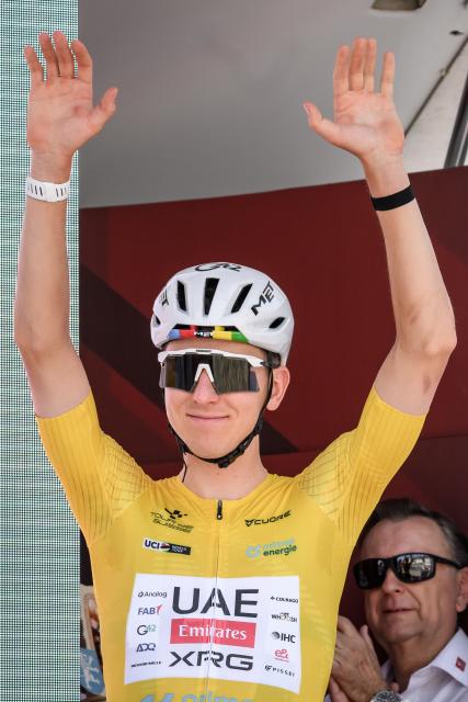 UAE Team Emirates-XRG's Slovenian rider Tadej Pogacar gestures during the team presentation of second stage of the Men's Tour of Switzerland (Tour de Suisse) cycling race, in Locarno, Switzerland, on June 18, 2026. (Photo by Fabrice COFFRINI / AFP)
