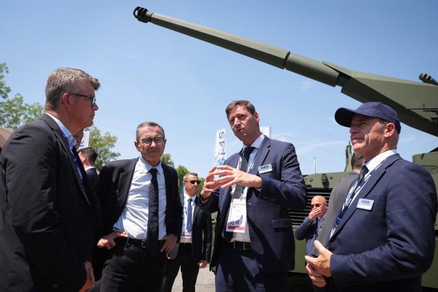 The president of French right-wing party Les Republicains (LR) and 2027 presidential election candidate Bruno Retailleau (2nd L) listens to CEO of French weapons manufacturer KNDS Nicolas Groult (2nd R) at the KNDS stand during a visit of the Eurosatory, a land and airland defence and security trade fair in Villepinte on the outskirts of Paris, on June 18, 2026. and Guest (Photo by Thomas SAMSON / AFP)