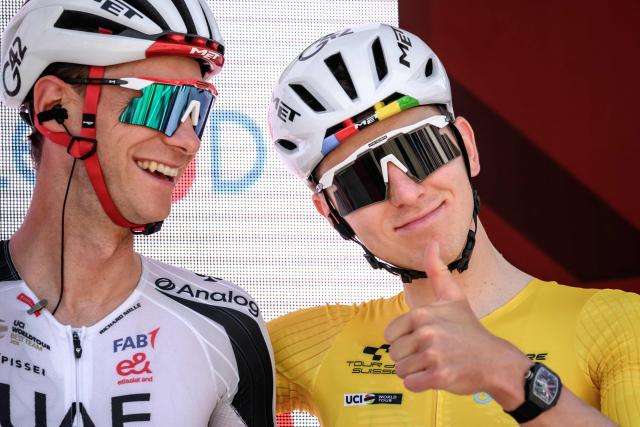 UAE Team Emirates XRG’s Slovenian rider Tadej Pogacar (R) gives a thumb up next to teammate Austrian rider Felix Grossschartner during the team presentation of the second stage of the Men’s Tour of Switzerland (Tour de Suisse) cycling race in Locarno, Switzerland, on June 18, 2026. (Photo by Fabrice COFFRINI / AFP)