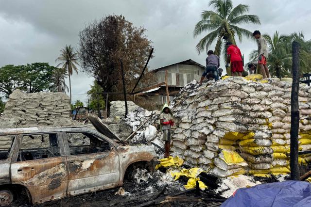People clear debris after an airstrike by Myanmar's military in Kyauktaw, western Rakhine State on June 18, 2026. A Myanmar military airstrike has killed seven civilians including a five-year-old child in the country's conflict-ravaged west, a witness and a rescue worker said on June 18. (Photo by AFP)