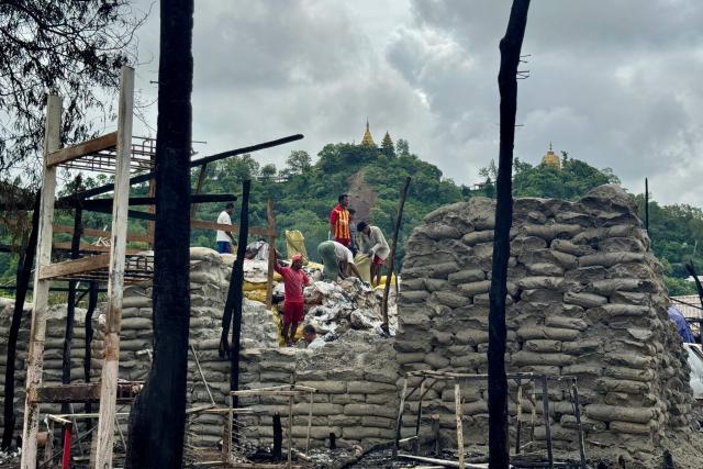 People clear debris after an airstrike by Myanmar's military in Kyauktaw, western Rakhine State on June 18, 2026. A Myanmar military airstrike has killed seven civilians including a five-year-old child in the country's conflict-ravaged west, a witness and a rescue worker said on June 18. (Photo by AFP)