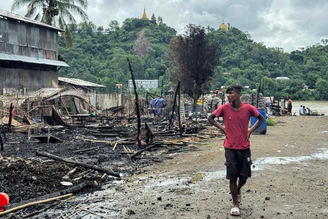A man walks past the ruins of a building after an airstrike by Myanmar's military in Kyauktaw, western Rakhine State on June 18, 2026. A Myanmar military airstrike has killed seven civilians including a five-year-old child in the country's conflict-ravaged west, a witness and a rescue worker said on June 18. (Photo by AFP)