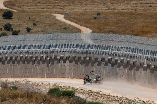 An Israeli army humvee vehicle patrols along the northern border with Lebanon in the Upper Galilee  on June 18, 2026. Israeli strikes in south Lebanon killed three people on June 18, according to Lebanese state media, hours after the United States and Iran signed an agreement to end the Middle East war. Israel's military, meanwhile, announced the death of one of its soldiers the night before in an incident in south Lebanon that also left seven others wounded. (Photo by Jalaa MAREY / AFP)