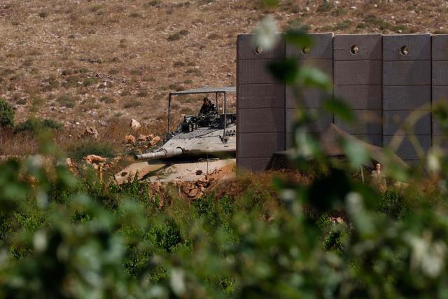 An Israeli army Merkava tank takes position along the northern border with Lebanon in the Upper Galilee on June 18, 2026. Israeli strikes in south Lebanon killed three people on June 18, according to Lebanese state media, hours after the United States and Iran signed an agreement to end the Middle East war. Israel's military, meanwhile, announced the death of one of its soldiers the night before in an incident in south Lebanon that also left seven others wounded. (Photo by Jalaa MAREY / AFP)