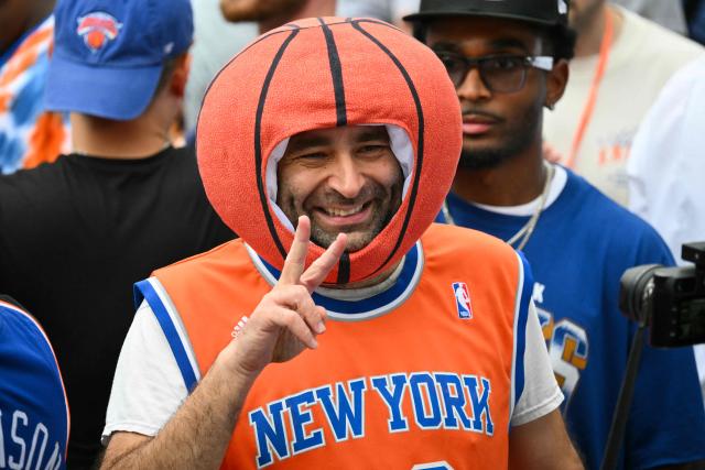 A New York Knicks fan wearing a basketball hat, attends at City Hall Plaza in New York City on June 18, 2026, ahead of the championship celebration and Key to the City ceremony after a ticker-tape parade honoring the team's NBA Finals victory. (Photo by ANGELA WEISS / AFP)