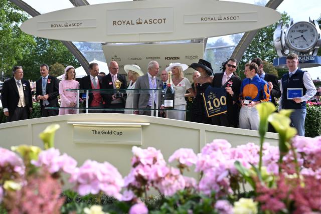 Britain's King Charles, Britain's Queen Camilla, Trainer Aidan O'Brien and Jockey Ryan Moore attend the trophy presentation for the The Gold Cup race on the third day of the Royal Ascot horse racing meeting in Ascot, west of London, on June 18, 2026. (Photo by JUSTIN TALLIS / AFP)