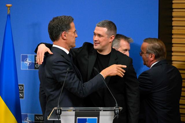 (From L) NATO Secretary General Mark Rutte greets Ukraine's Defence Minister Mykhailo Fedorov at the end of a press conference following a meeting of the Ukraine Defence Contact Group on the sidelines of a NATO Defence Ministers meeting at the NATO headquarters, in Brussels, on June 18, 2026. (Photo by JOHN THYS / AFP)