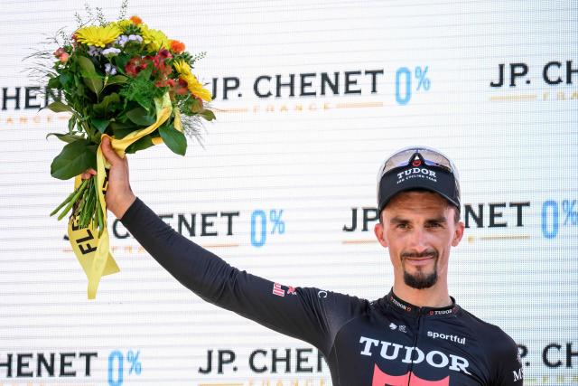 Tudor Pro Cycling Team's French rider Julian Alaphilippe, awarded as best fighter of the stage, gestures during the podium ceremony of the second stage 157,7 km from Locarno to Locarno at the Men’s Tour of Switzerland (Tour de Suisse) cycling race in Locarno, Switzerland, on June 18, 2026. (Photo by Fabrice COFFRINI / AFP)