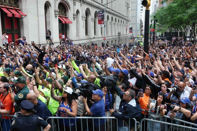 Fans of the New York Knicks attend a championship ticker-tape parade celebrating the team's NBA Finals victory in New York on June 18, 2026. (Photo by TIMOTHY A. CLARY / AFP)