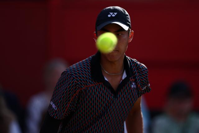 A tennis ball obscures the face of Australia's Rinky Hijikata during their men's singles round of 16 tennis match on day three of the ATP HSBC Championships at Queen's Club in west London on June 18, 2026. (Photo by Henry Nicholls / AFP)