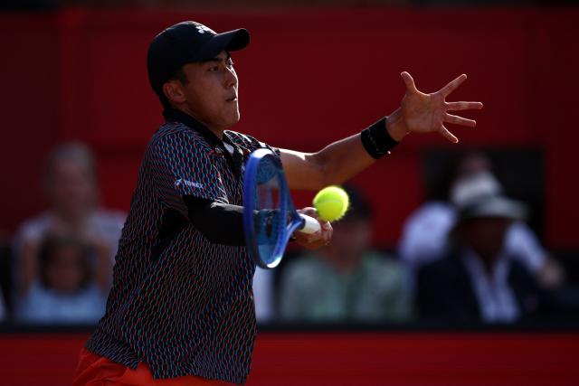 Australia's Rinky Hijikata returns against Czech Republic's Jiri Lehecka during their men's singles round of 16 tennis match on day three of the ATP HSBC Championships at Queen's Club in west London on June 18, 2026. (Photo by Henry Nicholls / AFP)