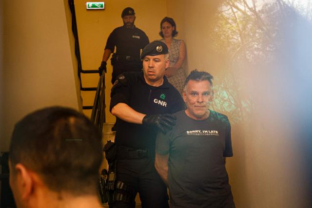 (FILES) Frenchwoman Marine R. (Top R) and Frenchman Marc B. (Bottom R) are escorted from the Setubal courthouse, where a French woman and her partner suspected of abandoning two children were appearing in Setubal, Portugal, on May 23, 2026. The Portuguese authorities have agreed to execute the arrest warrant issued by France for the partner of a French woman suspected of having abandoned her children in Portugal last month, but only once the Iberian countrys justice system no longer has an interest in keeping him in custody, the competent court announced on June 18, 2026. (Photo by FILIPE AMORIM / AFP)